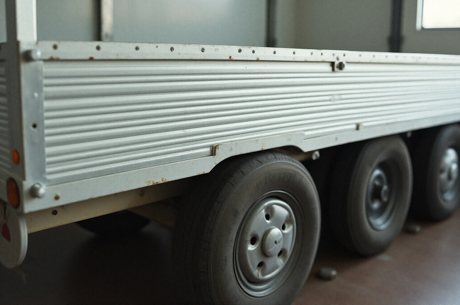 A loading ramp and the lower half of a car wheel on a trailer deck